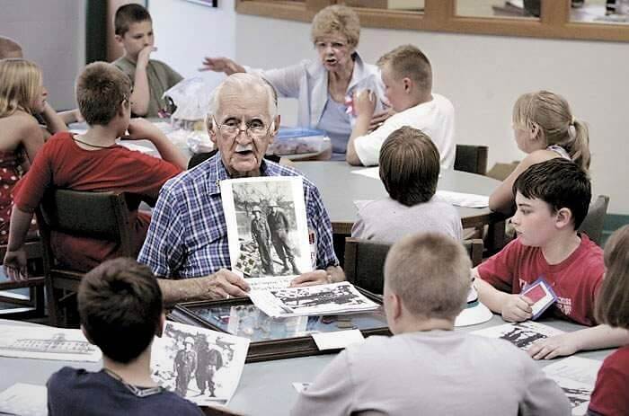 Frank Douglas teaching school children about WWII, photo by Christopher Rabuck